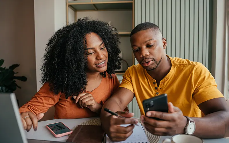 couple with papers and laptop